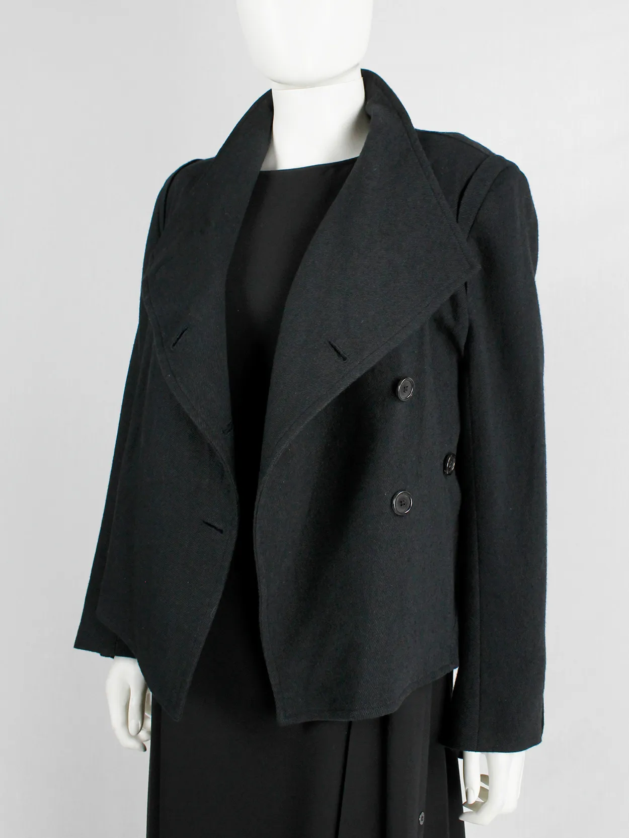 Ann Demeulemeester black coat with standing neckline and asymmetric button closure — fall 2010