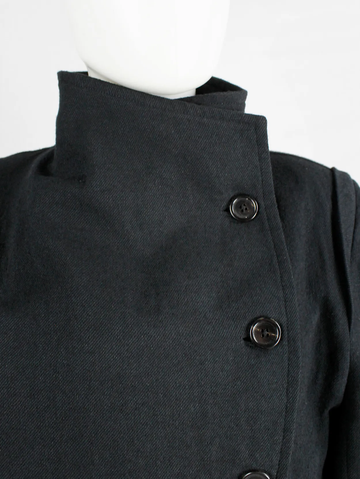 Ann Demeulemeester black coat with standing neckline and asymmetric button closure — fall 2010