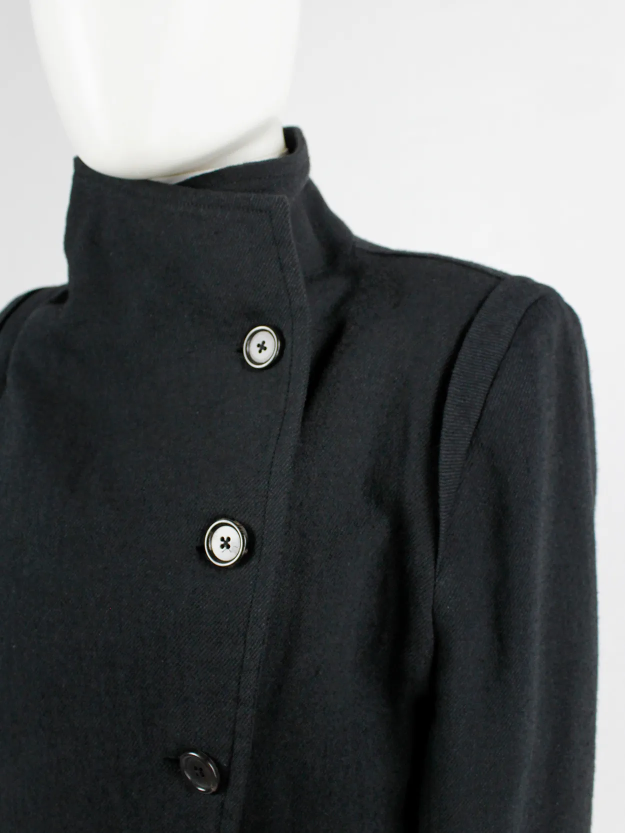 Ann Demeulemeester black coat with standing neckline and asymmetric button closure — fall 2010