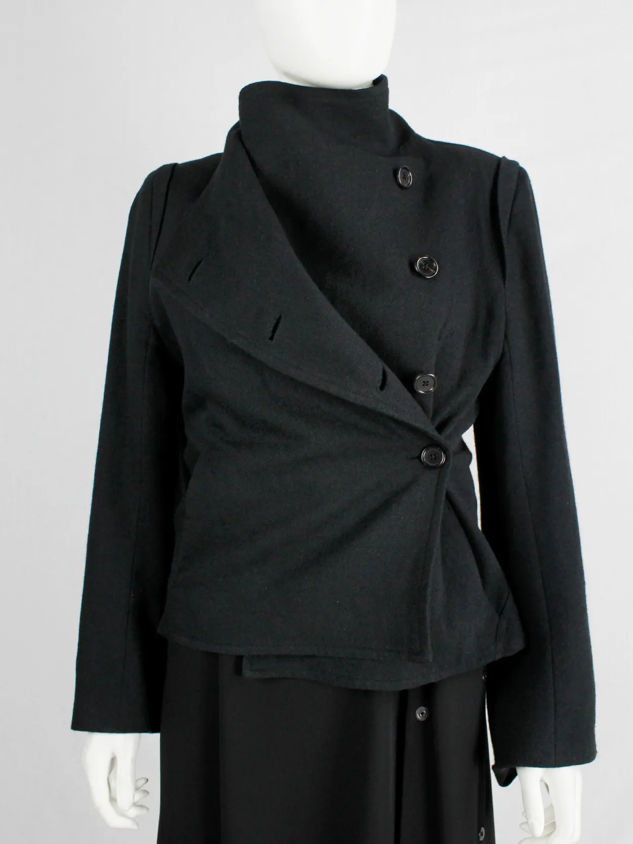 Ann Demeulemeester black coat with standing neckline and asymmetric button closure — fall 2010