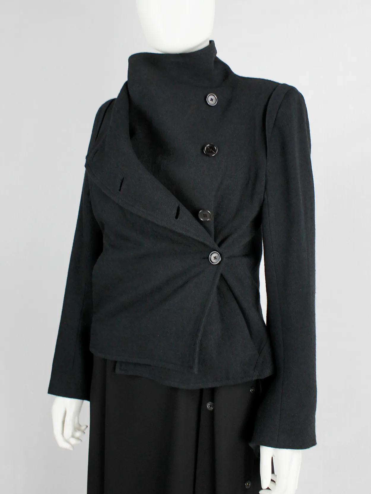 Ann Demeulemeester black coat with standing neckline and asymmetric button closure — fall 2010