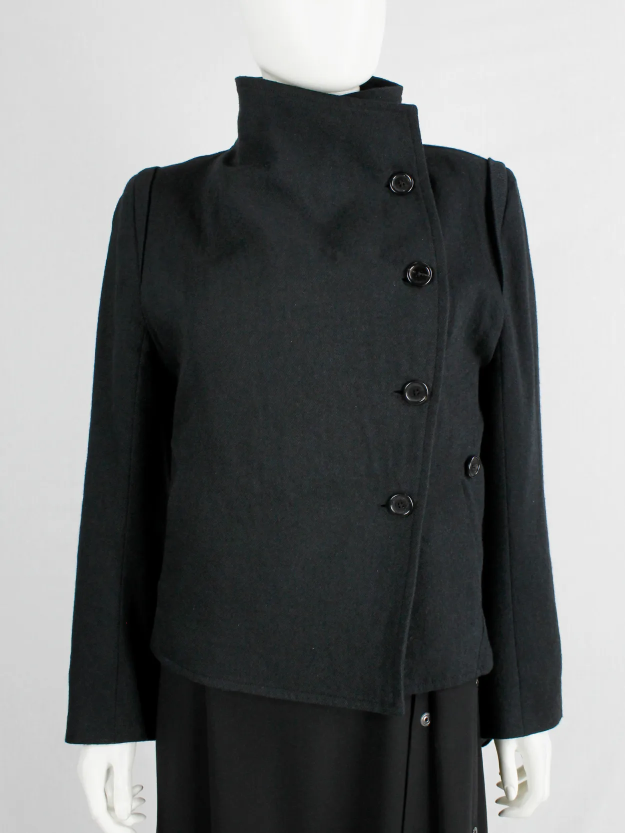 Ann Demeulemeester black coat with standing neckline and asymmetric button closure — fall 2010