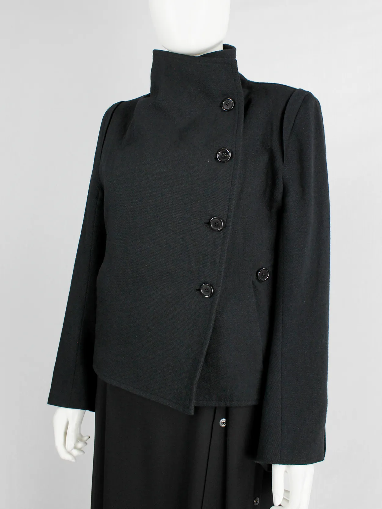 Ann Demeulemeester black coat with standing neckline and asymmetric button closure — fall 2010