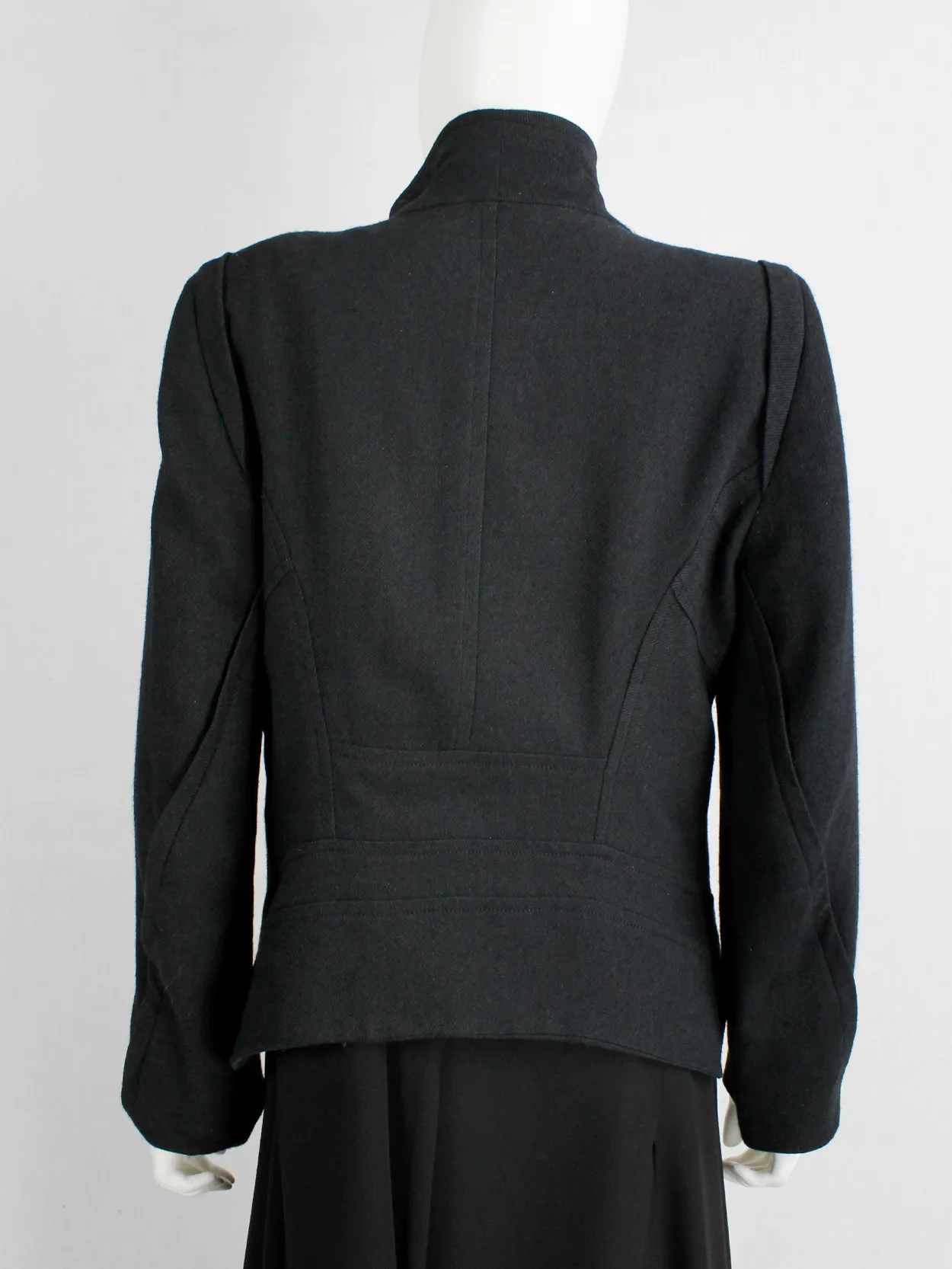 Ann Demeulemeester black coat with standing neckline and asymmetric button closure — fall 2010